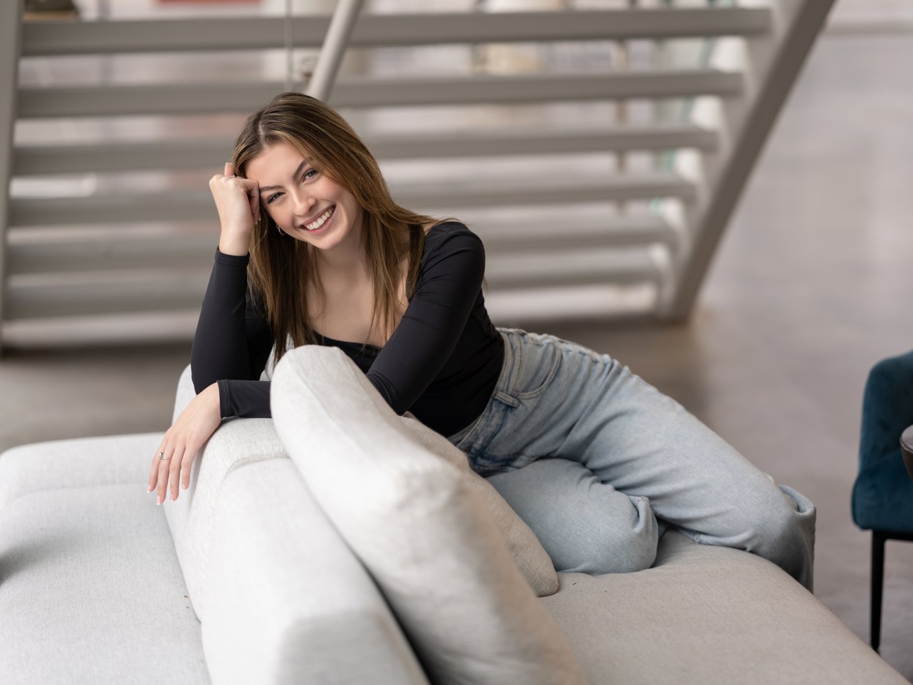 A lifestyle pose over the couch for Annie's Cedar Rapids Senior Pictures