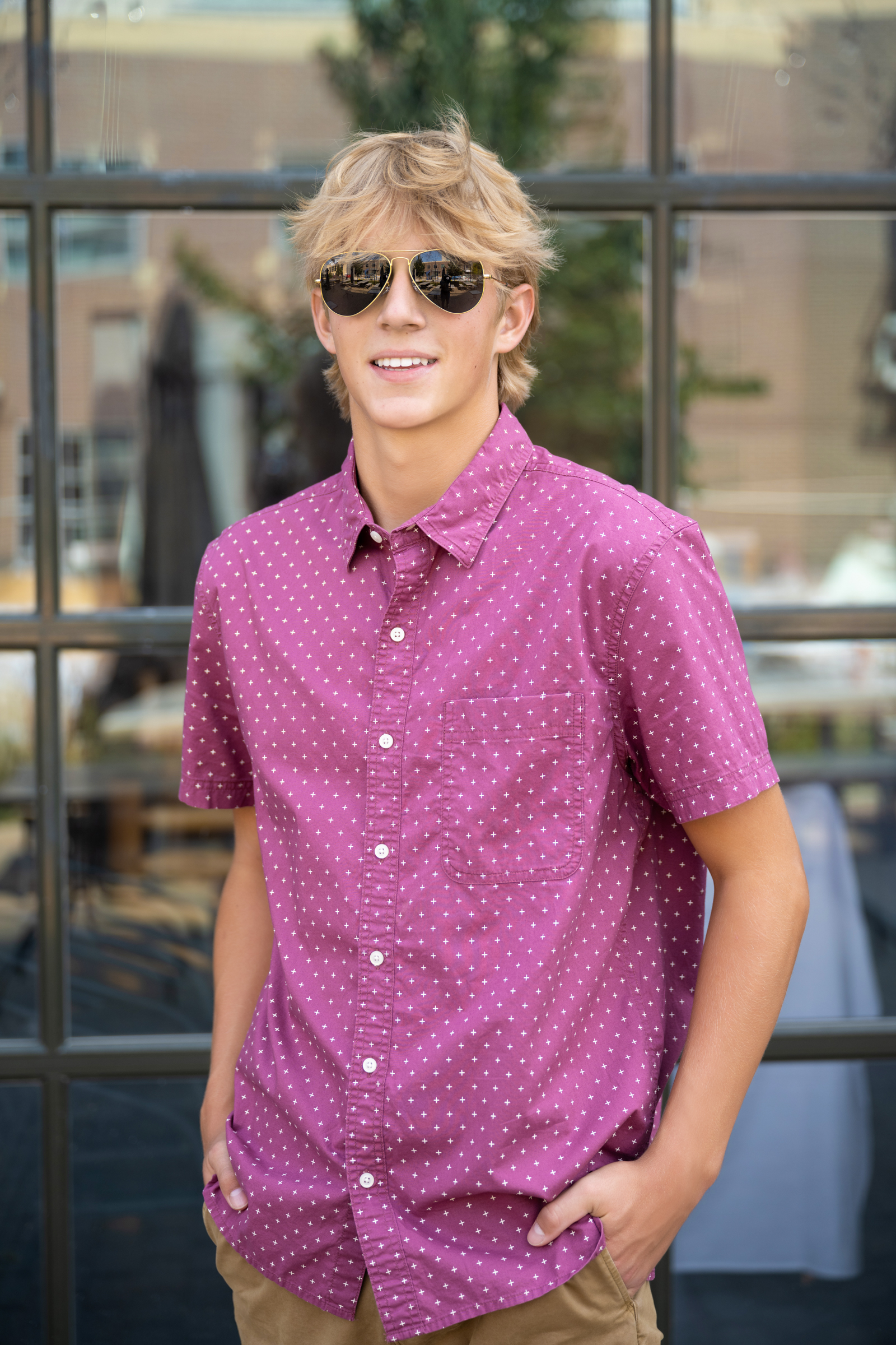 Cole wearing aviator sunglasses at the Iowa City Pedestrian mall for his senior pictures